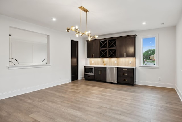 512 Wilson Pike, Brentwood, TN 37027 - indoor bar featuring light wood finished floors, a chandelier, pendant lighting, stainless steel appliances, and recessed lighting
