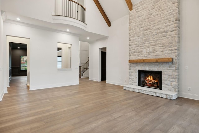 512 Wilson Pike, Brentwood, TN 37027 - unfurnished living room with a fireplace, stairway, beam ceiling, wood finished floors, and high vaulted ceiling