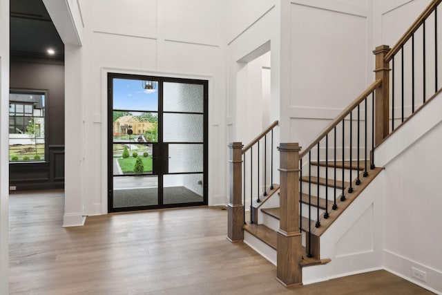 512 Wilson Pike, Brentwood, TN 37027 - foyer featuring a decorative wall, wood finished floors, and stairs