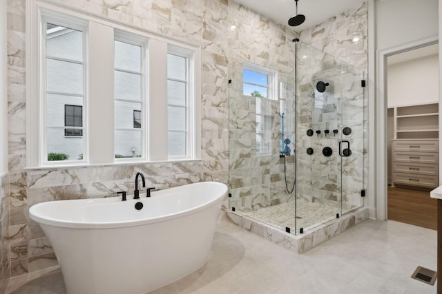 512 Wilson Pike, Brentwood, TN 37027 - bathroom with a stall shower, a soaking tub, tile walls, and a walk in closet