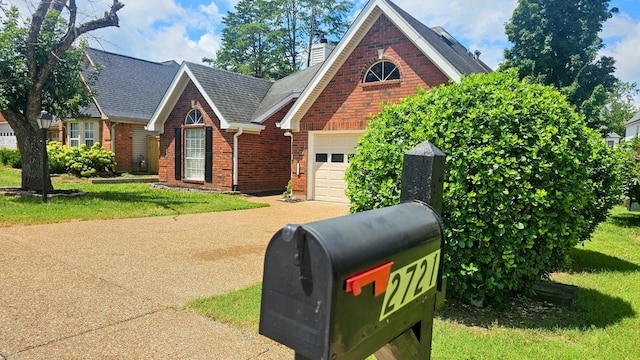 2721 Fleet Dr, Hermitage, TN 37076 - view of front of house with brick siding, driveway, a garage, and a front lawn