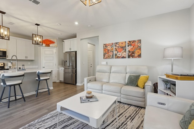 3225 Brookberry Ln, Murfreesboro, TN 37129 - living room with wood finished floors, a chandelier, and recessed lighting