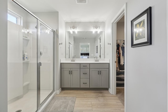 3225 Brookberry Ln, Murfreesboro, TN 37129 - full bath featuring a stall shower, double vanity, a walk in closet, and wood finished floors