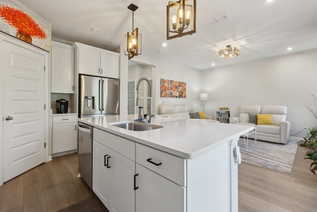 3225 Brookberry Ln, Murfreesboro, TN 37129 - kitchen with wood finished floors, appliances with stainless steel finishes, open floor plan, recessed lighting, and light countertops