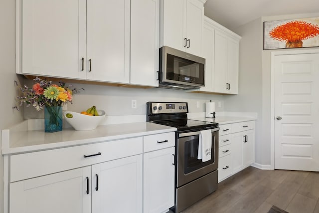3225 Brookberry Ln, Murfreesboro, TN 37129 - kitchen with appliances with stainless steel finishes, dark wood-type flooring, light countertops, and white cabinetry