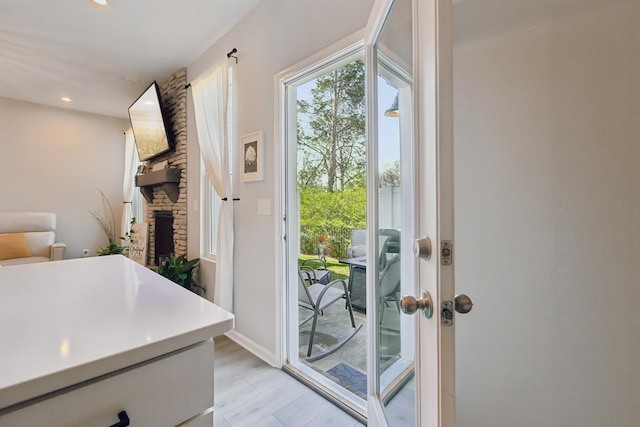 3225 Brookberry Ln, Murfreesboro, TN 37129 - doorway to outside featuring recessed lighting, a stone fireplace, and light wood-style flooring