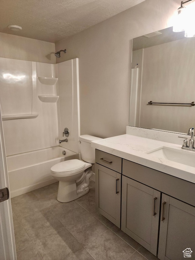 9786 N Aaron Ave E Unit 221, Eagle Mountain, UT 84005 - full bathroom with vanity, tile patterned flooring, a textured ceiling, toilet, and shower / bathtub combination