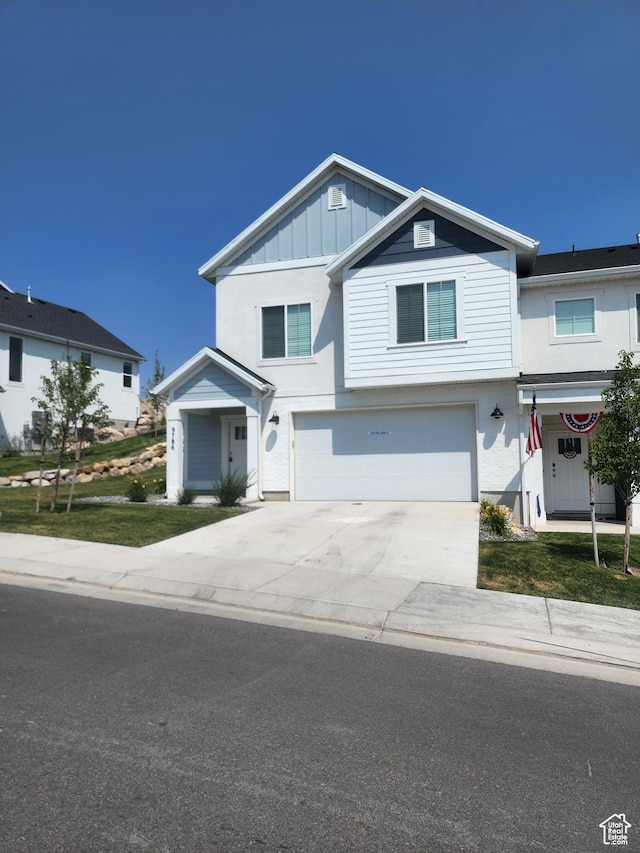 9786 N Aaron Ave E Unit 221, Eagle Mountain, UT 84005 - view of front of property featuring a garage, board and batten siding, and concrete driveway