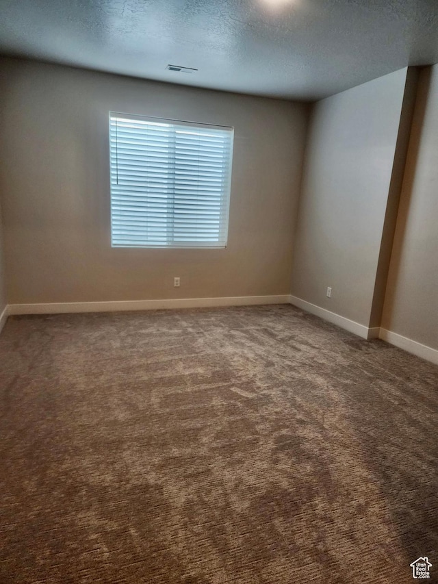 9786 N Aaron Ave E Unit 221, Eagle Mountain, UT 84005 - empty room featuring a textured ceiling, carpet flooring, baseboards, and visible vents