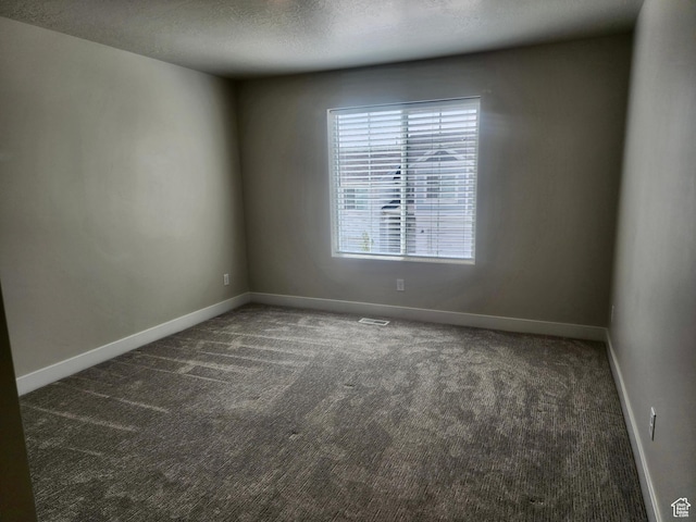 9786 N Aaron Ave E Unit 221, Eagle Mountain, UT 84005 - spare room featuring carpet, visible vents, baseboards, and a textured ceiling