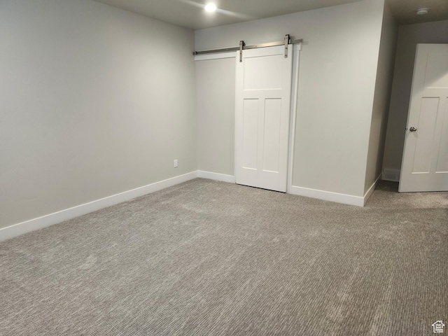 9786 N Aaron Ave E Unit 221, Eagle Mountain, UT 84005 - unfurnished bedroom featuring baseboards, carpet, and a barn door