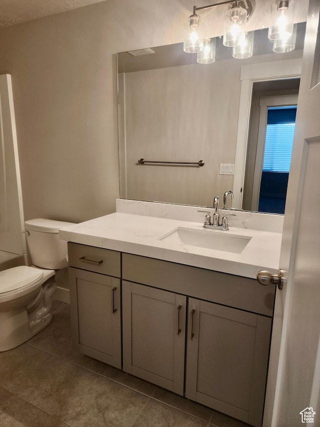 9786 N Aaron Ave E Unit 221, Eagle Mountain, UT 84005 - bathroom featuring tile patterned floors, toilet, vanity, and baseboards