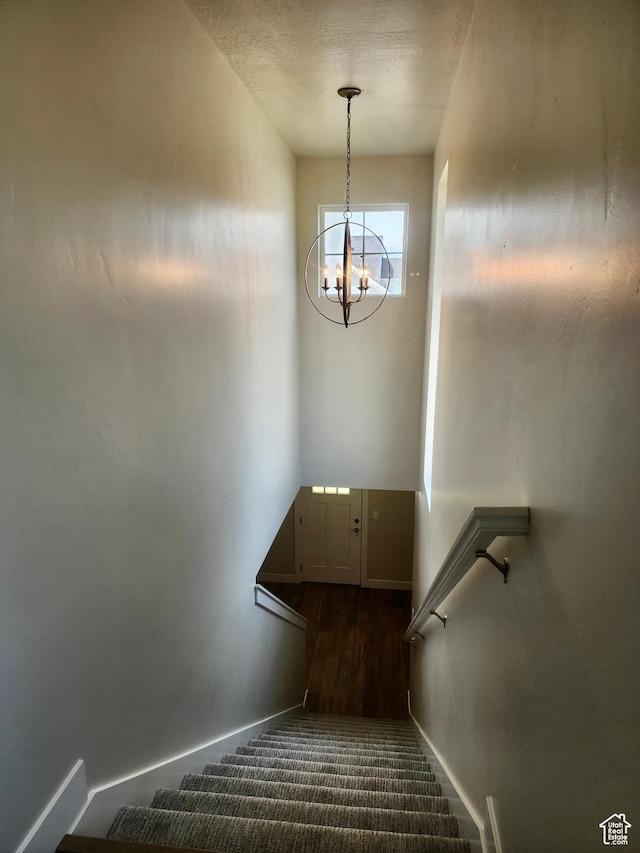 9786 N Aaron Ave E Unit 221, Eagle Mountain, UT 84005 - staircase with baseboards and an inviting chandelier