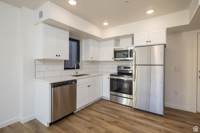 1185 S Murphy Ln Unit 105D, Moab, UT 84532 - kitchen featuring stainless steel appliances, a sink, white cabinets, backsplash, and recessed lighting