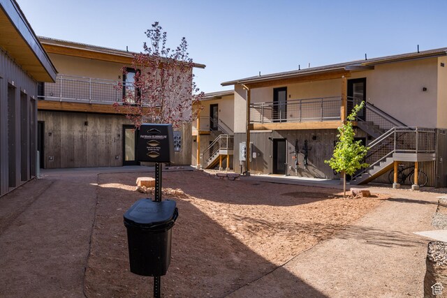 1185 S Murphy Ln Unit 106B, Moab, UT 84532 - rear view of house with stairs and stucco siding