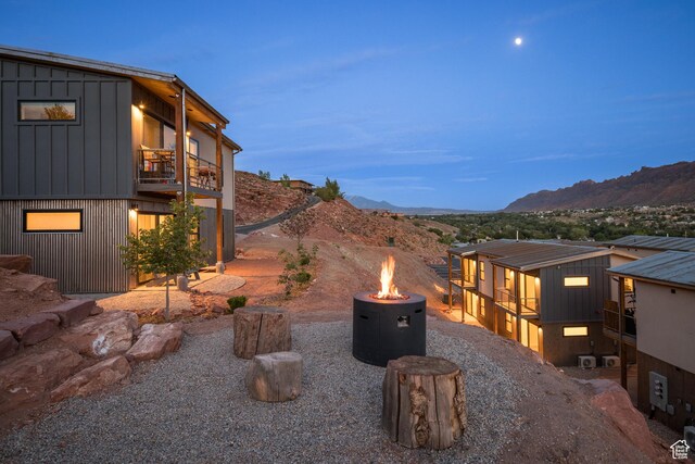 1185 S Murphy Ln Unit 106B, Moab, UT 84532 - view of yard with an outdoor fire pit, a balcony, and a mountain view