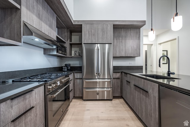 2417 W High Mountain Rd Unit 2109, Park City, UT 84098 - kitchen with dark stone counters, appliances with stainless steel finishes, decorative light fixtures, sink, and light hardwood / wood-style flooring