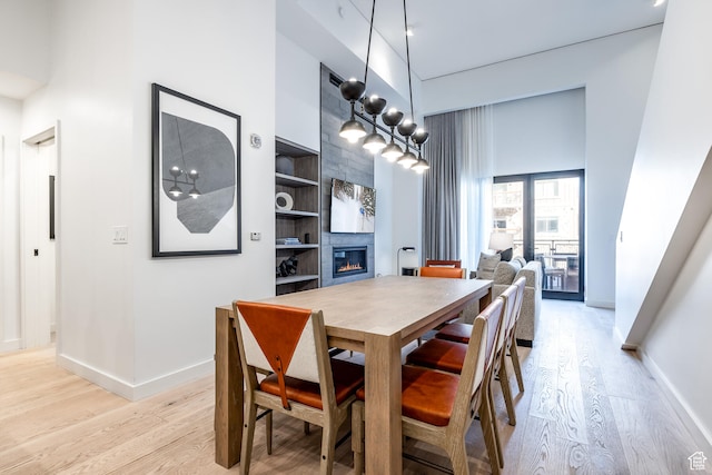 2417 W High Mountain Rd Unit 2109, Park City, UT 84098 - dining area with built in shelves, light hardwood / wood-style floors, and a high ceiling