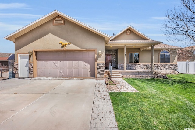 view of front of property with covered porch, a front yard, and a garage