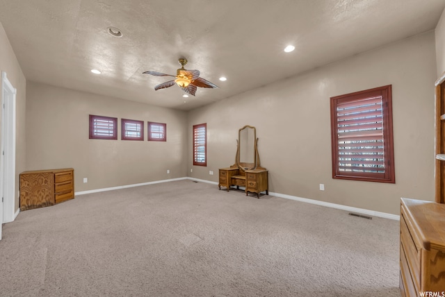 unfurnished room with ceiling fan and light carpet