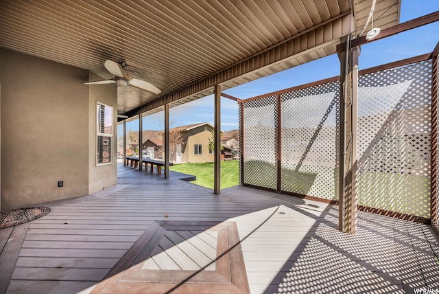 deck with a yard and ceiling fan