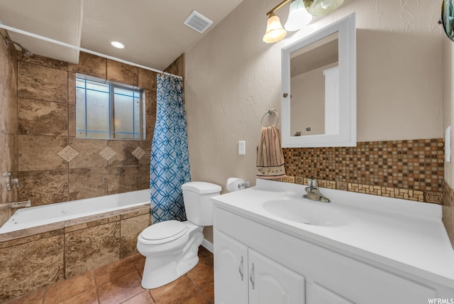 full bathroom featuring shower / bath combination with curtain, toilet, vanity with extensive cabinet space, and tile flooring