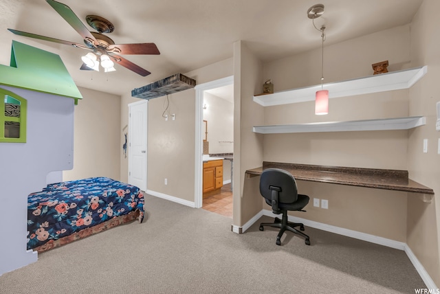 bedroom with ceiling fan, built in desk, light tile floors, and ensuite bath