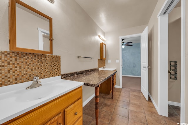 bathroom with backsplash, large vanity, ceiling fan, and tile flooring