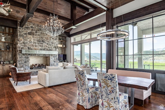 dining room featuring a chandelier, beamed ceiling, plenty of natural light, hardwood / wood-style flooring, and wood ceiling