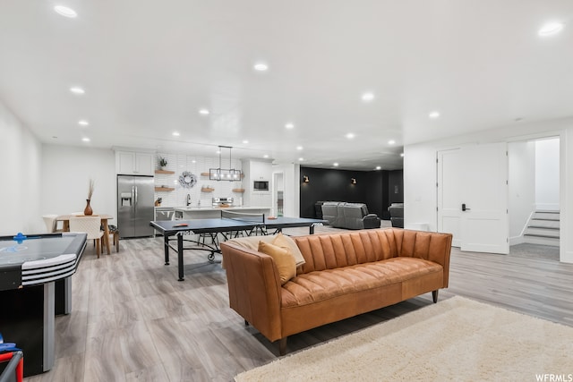 living room featuring light hardwood / wood-style floors and sink