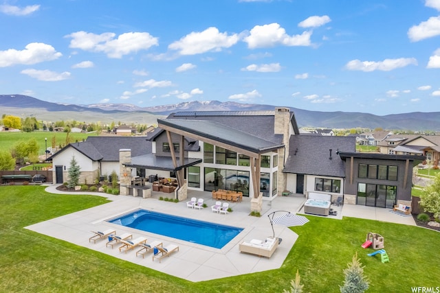 exterior space featuring a yard, a mountain view, an outdoor living space, and a patio