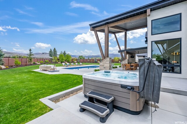 view of patio featuring a swimming pool with hot tub