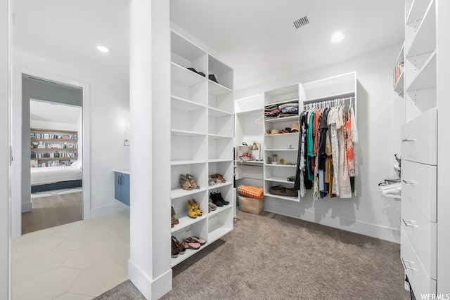 walk in closet featuring carpet