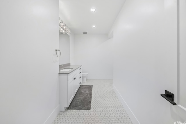 bathroom with tile floors, toilet, and vanity