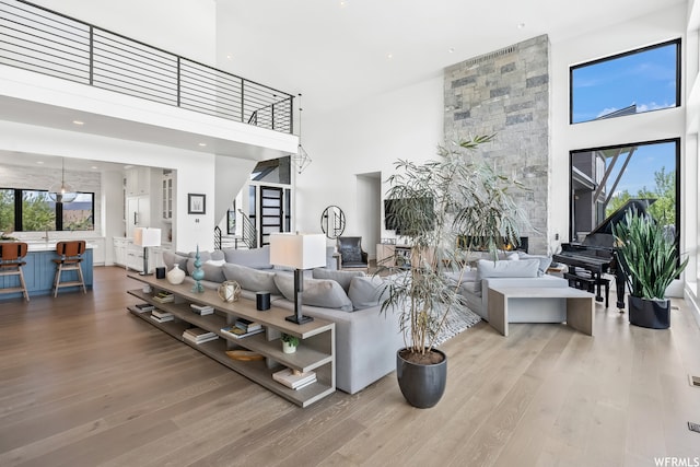 living room with a high ceiling and light hardwood / wood-style floors