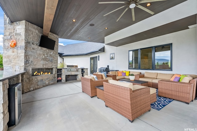 living room featuring wooden ceiling, ceiling fan, and an outdoor stone fireplace