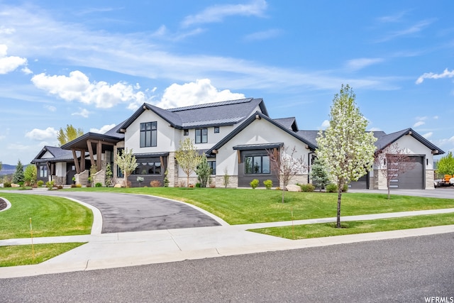 view of front of house with a front yard and a garage