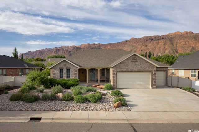 487 Kiva Dr, Moab, UT 84532 - ranch-style house with a mountain view and a garage