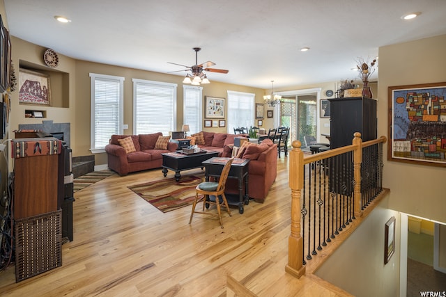 487 Kiva Dr, Moab, UT 84532 - living room featuring ceiling fan with notable chandelier and light wood-type flooring