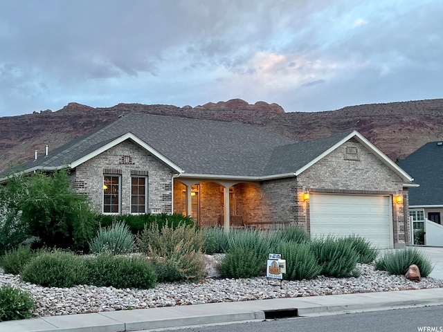ranch-style home with a mountain view and a garage