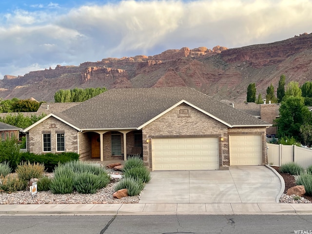 487 Kiva Dr, Moab, UT 84532 - ranch-style house featuring a mountain view and a garage