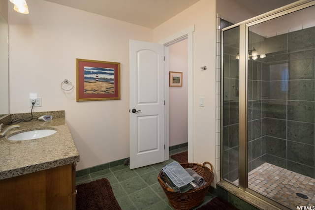 487 Kiva Dr, Moab, UT 84532 - bathroom featuring a shower with shower door, tile flooring, and vanity