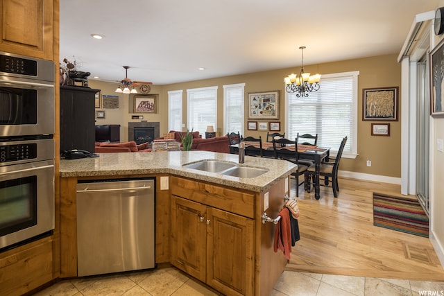 487 Kiva Dr, Moab, UT 84532 - kitchen featuring light tile floors, appliances with stainless steel finishes, a chandelier, and sink