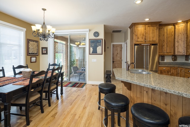 487 Kiva Dr, Moab, UT 84532 - dining space with a chandelier, light hardwood / wood-style floors, and sink