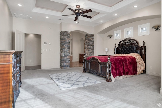 bedroom with ceiling fan, coffered ceiling, decorative columns, and light colored carpet