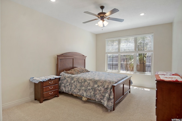 bedroom featuring light carpet and ceiling fan
