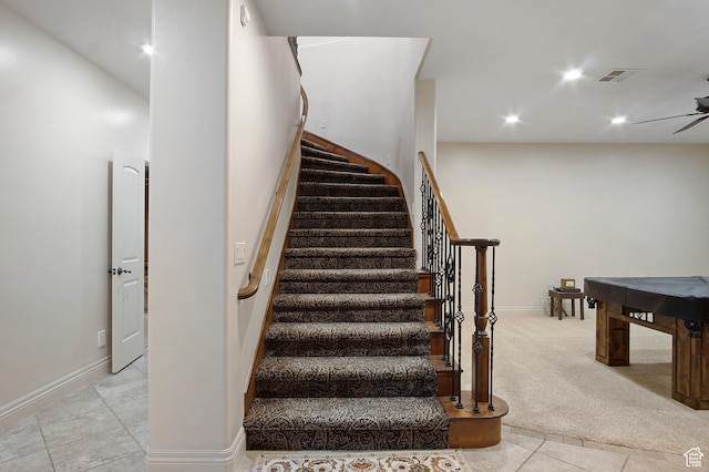 staircase with carpet and ceiling fan