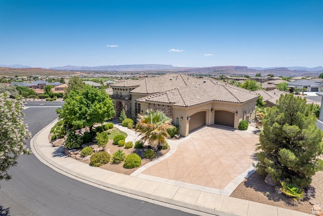 view of front of home featuring a garage and a mountain view