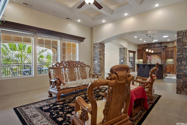dining room featuring light carpet, coffered ceiling, beamed ceiling, and ceiling fan