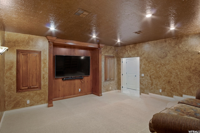 carpeted living room featuring a textured ceiling